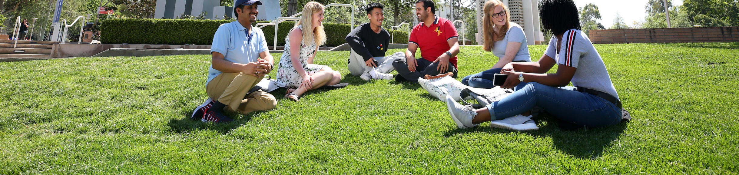 picture of students infront of UCR sign and bell tower
